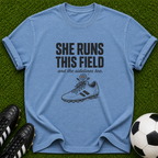 She Runs This Field soccer cleat T-shirt